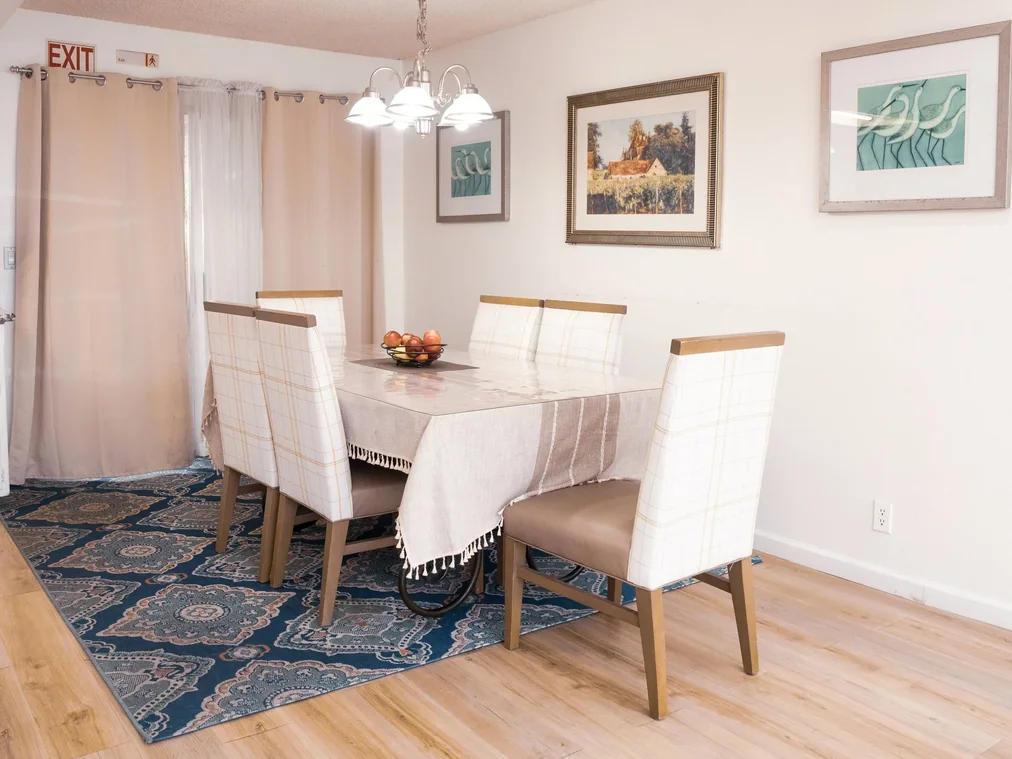 Spacious dining room with table seating for six residents