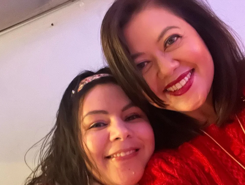 Caregiver and family member smiling together during a visit
