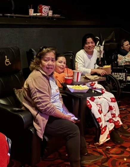 Residents enjoying a movie outing together at a theater