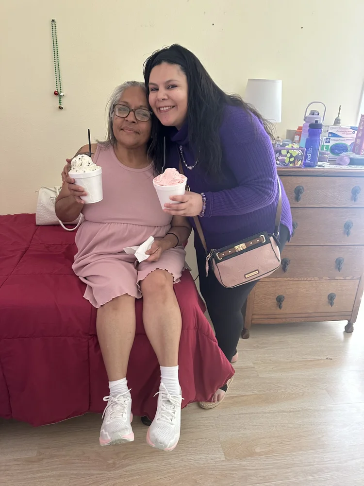 Caregiver and resident enjoying frozen desserts together in a comfortable home setting