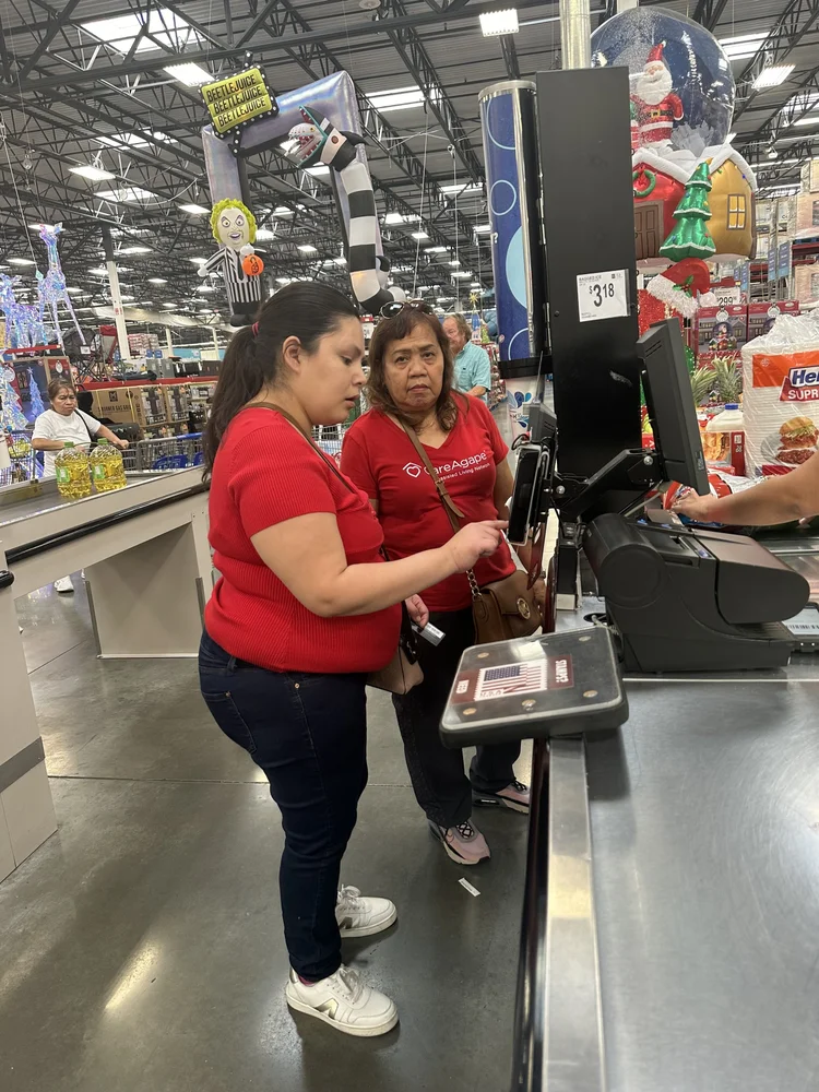 Staff members providing support during a community shopping activity