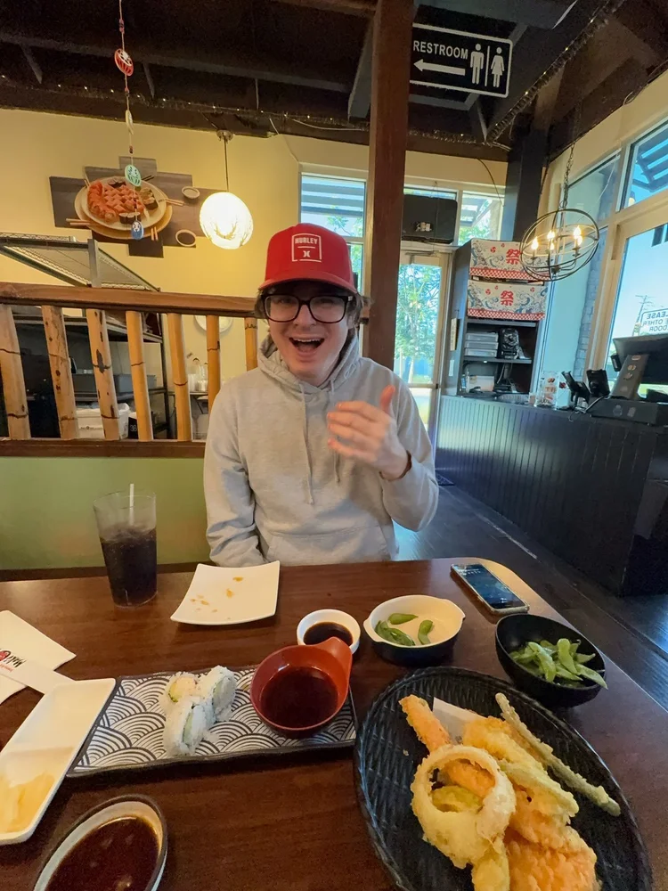 Resident enjoying a meal during a community dining outing at a local restaurant