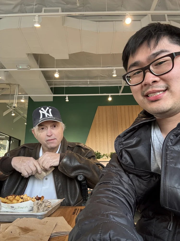 Two people enjoying a meal together in a welcoming community dining space